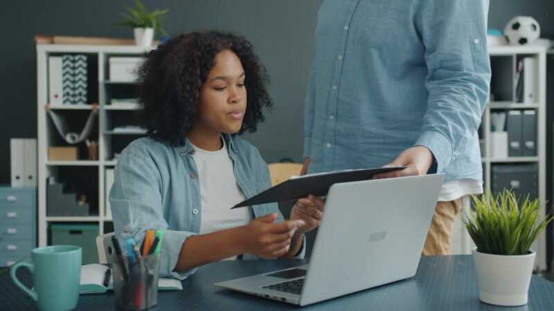 Colleagues reviewing a workplace policy document